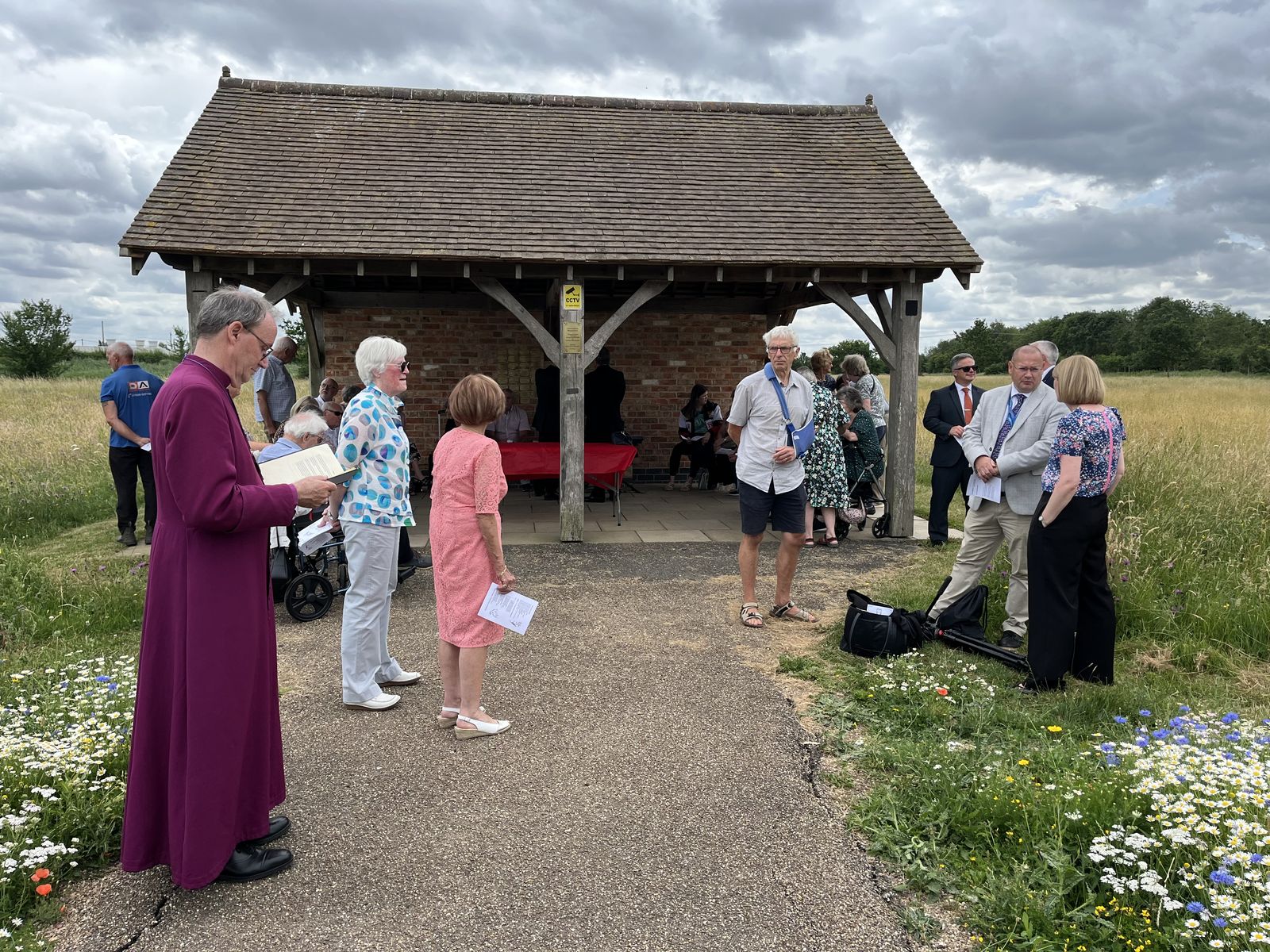 People gathering under the oak shelter for the final memorial service